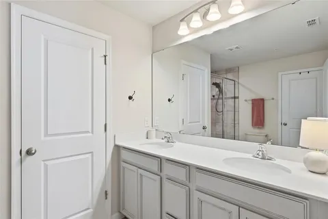 a bathroom with a glass shower door