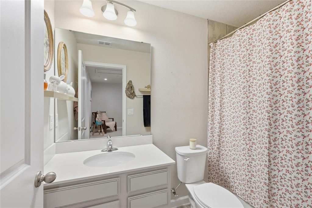 1788 Holden Ridge Ln. Minneola, FL 34715 - Photo 23 of 36 a bathroom with a sink a toilet and a mirror