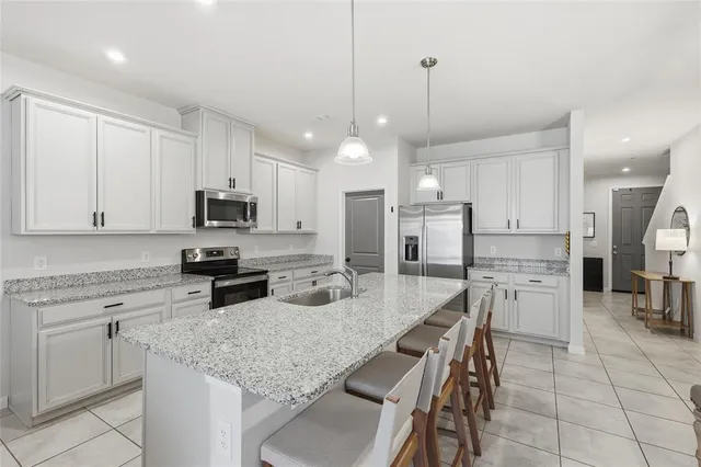 a kitchen with refrigerator and cabinets