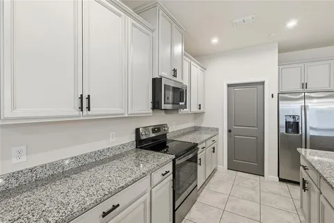 a kitchen with a refrigerator and a sink