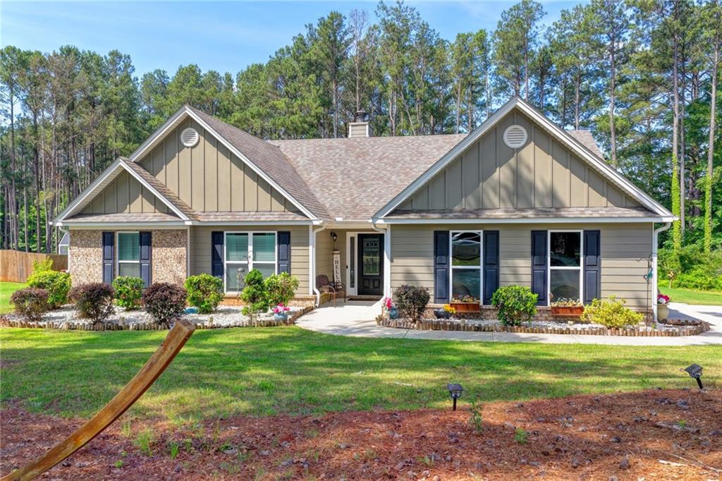 204 Lynn Road Bethlehem, GA 30620 - Photo 37 of 44 a front view of a house with garden and trees