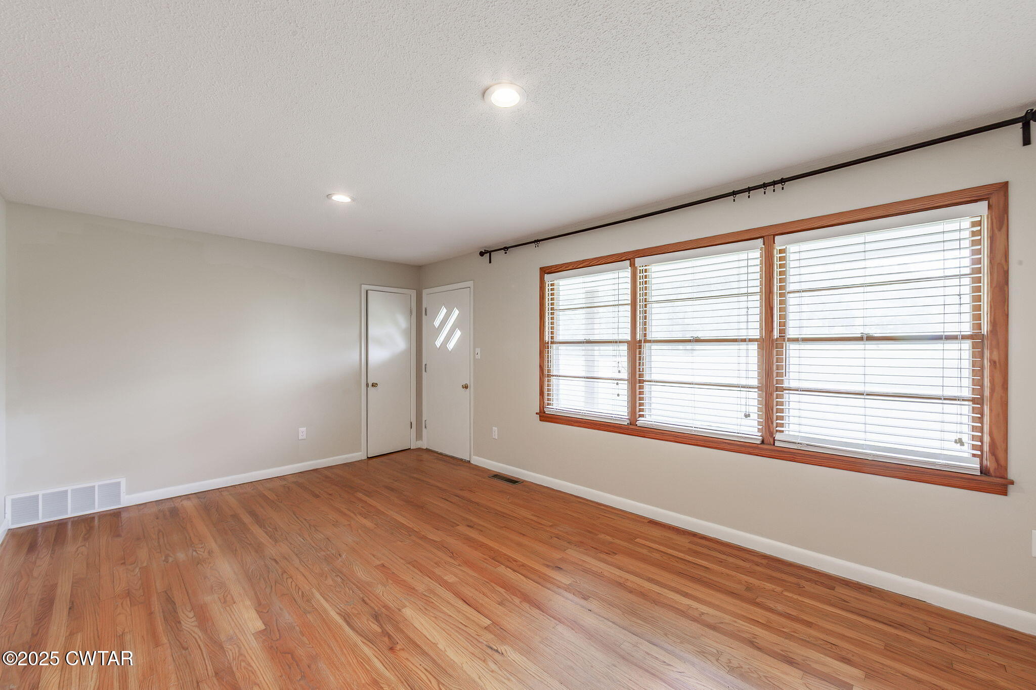 3810 Beech Bluff Road Jackson, TN 38301 - Photo 3 of 24 a view of empty room with wooden floor and fan