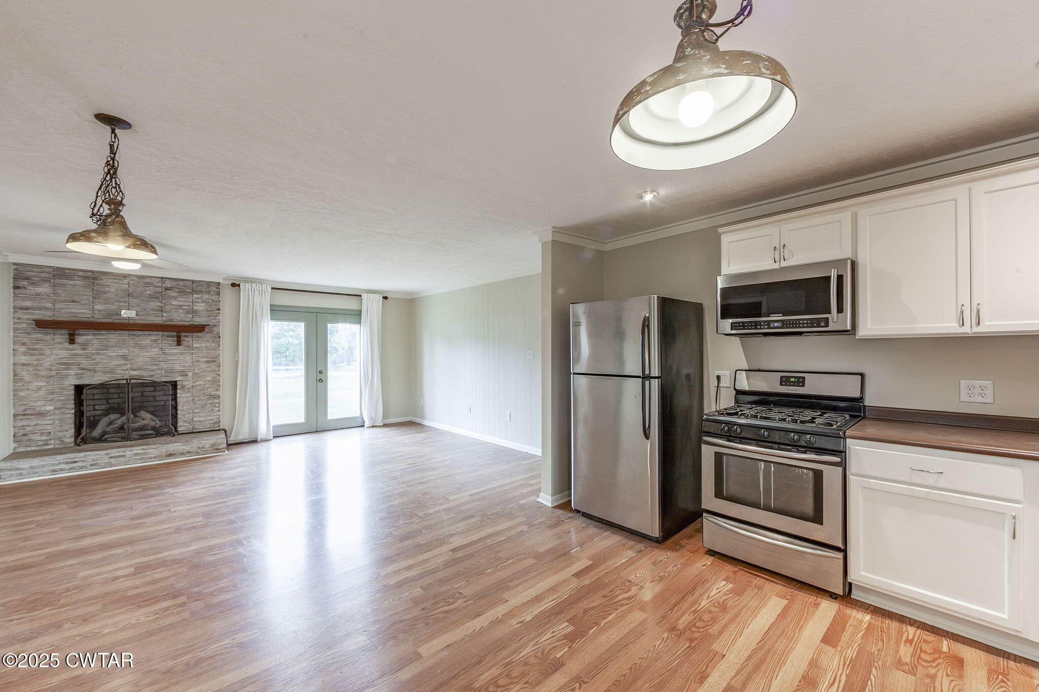 3810 Beech Bluff Road Jackson, TN 38301 - Photo 8 of 24 a kitchen with stainless steel appliances a stove refrigerator microwave and sink