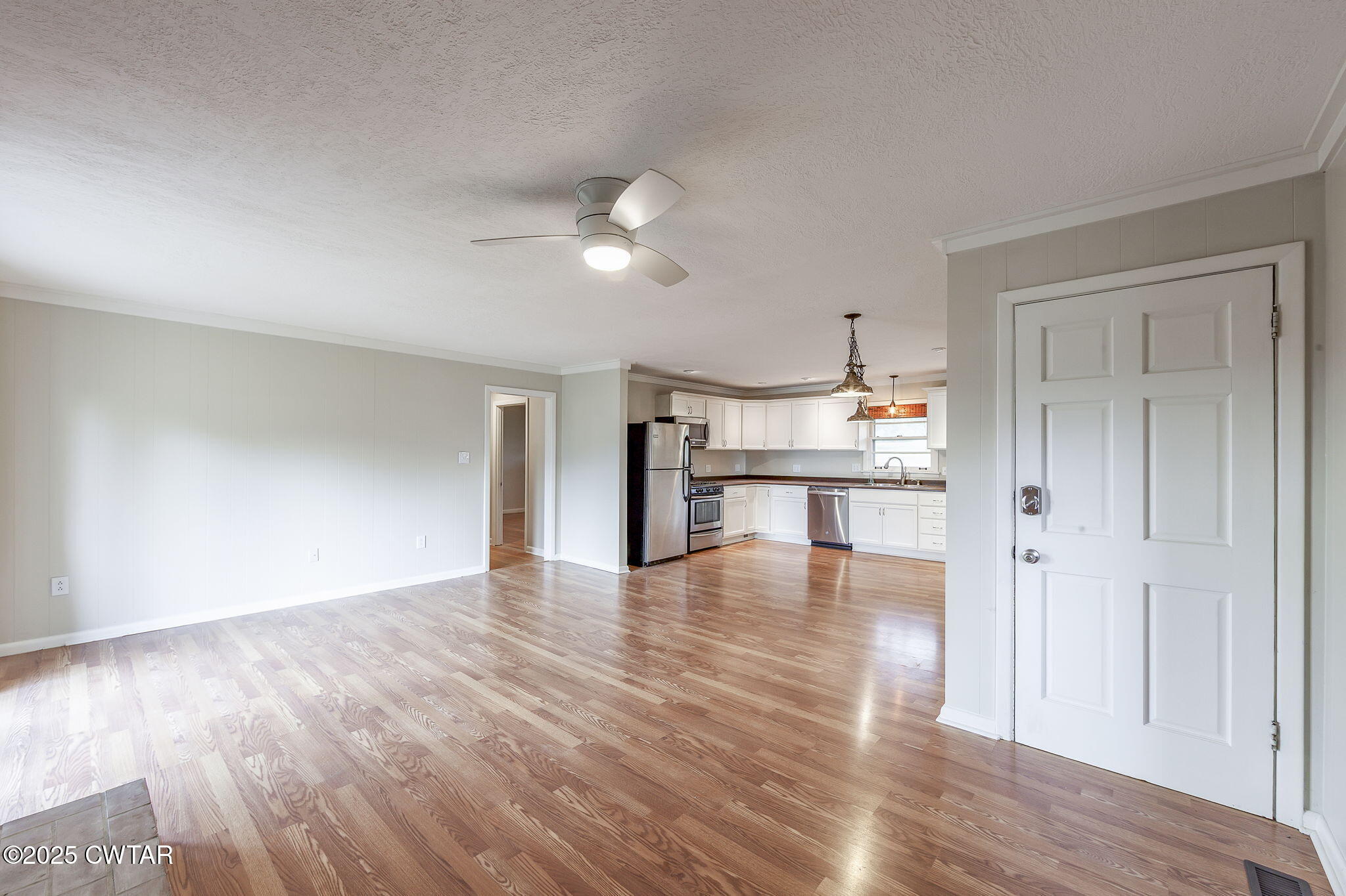 3810 Beech Bluff Road Jackson, TN 38301 - Photo 9 of 24 a view of empty room with wooden floor and kitchen view