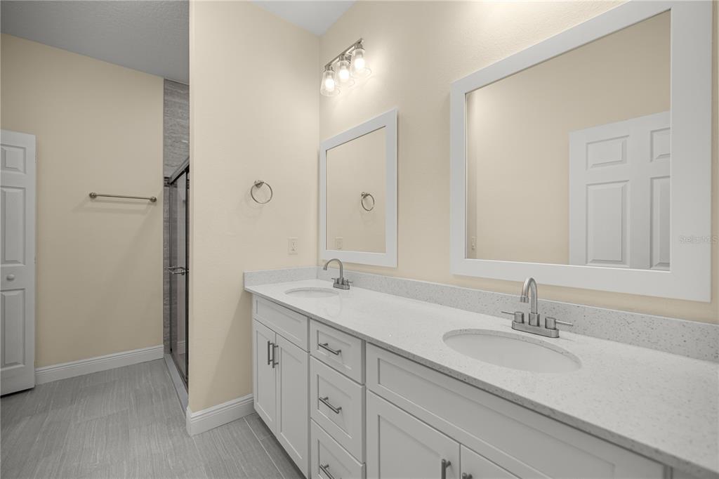 13745 Southwest 43rd Circle Ocala, FL 34473 - Photo 11 of 25 a bathroom with double sink and a mirror