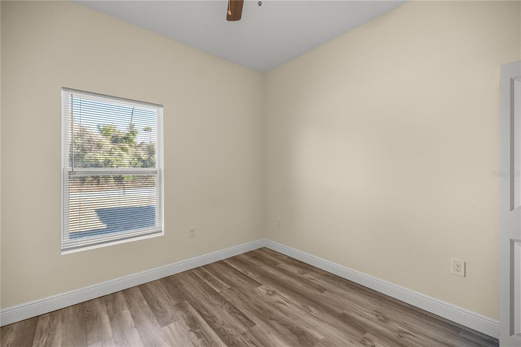 13745 Southwest 43rd Circle Ocala, FL 34473 - Photo 14 of 25 a view of an empty room with wooden floor and a window