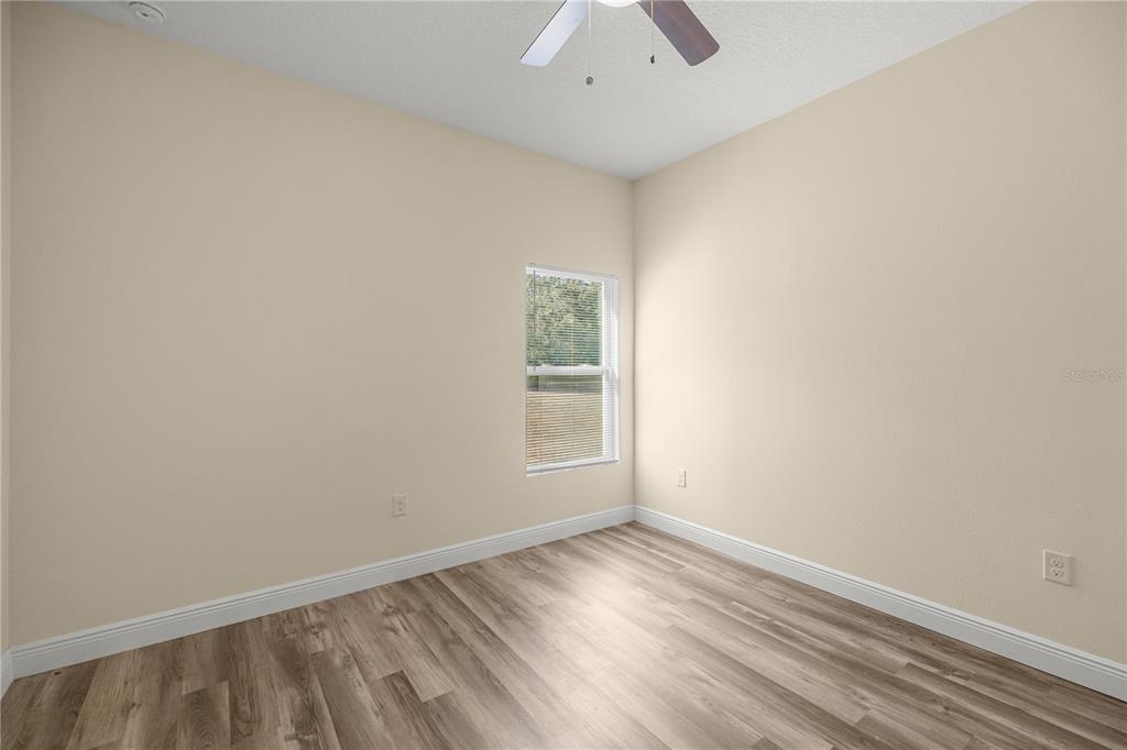 13745 Southwest 43rd Circle Ocala, FL 34473 - Photo 18 of 25 an empty room with wooden floor and windows