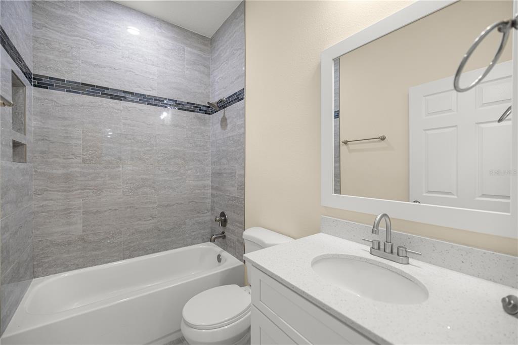 13745 Southwest 43rd Circle Ocala, FL 34473 - Photo 19 of 25 a bathroom with a bathtub shower sink vanity mirror and toilet