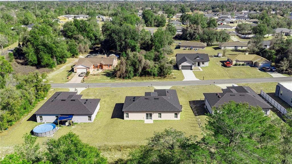 13745 Southwest 43rd Circle Ocala, FL 34473 - Photo 25 of 25 an aerial view of multiple houses with yard