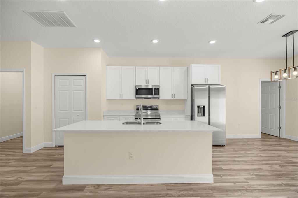 13745 Southwest 43rd Circle Ocala, FL 34473 - Photo 4 of 25 a large kitchen with stainless steel appliances