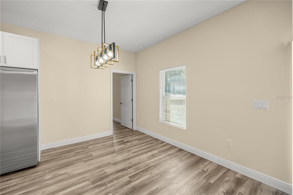 13745 Southwest 43rd Circle Ocala, FL 34473 - Photo 7 of 25 wooden floor in an empty room with a window