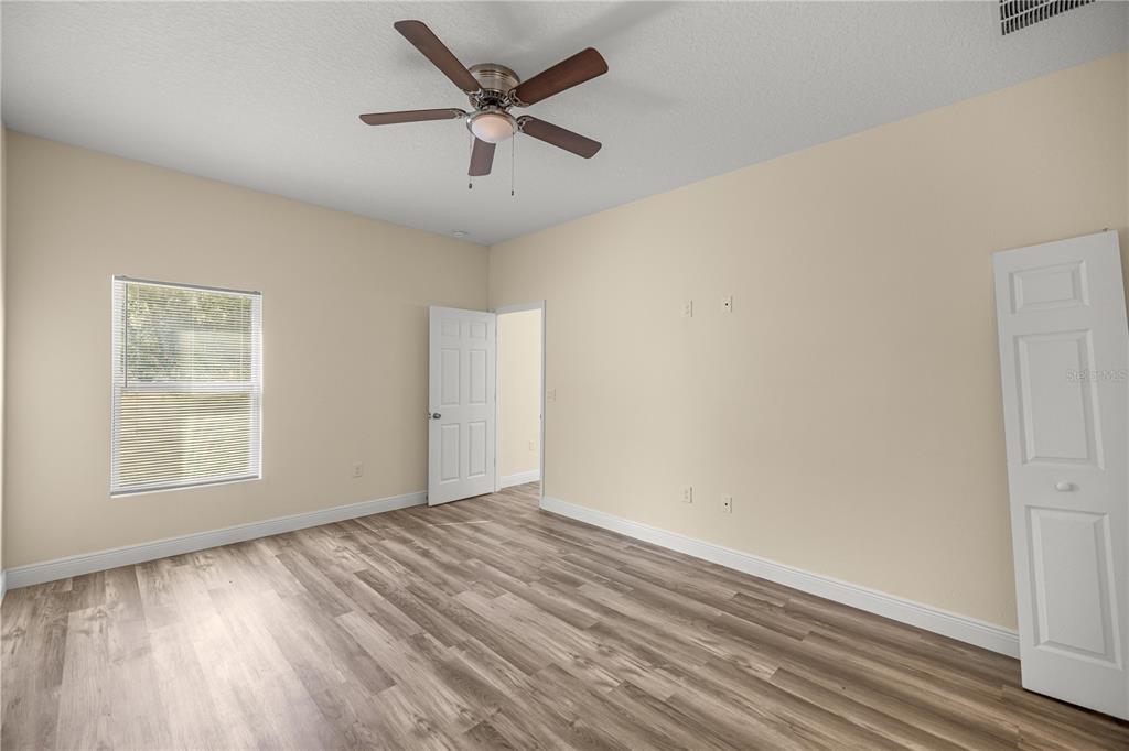 13745 Southwest 43rd Circle Ocala, FL 34473 - Photo 9 of 25 an empty room with wooden floor and windows