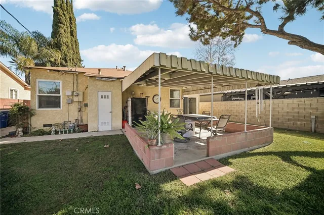 a view of a house with backyard porch and sitting area
