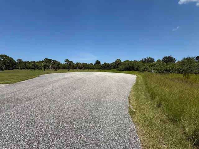 a view of a field and mountains in the background
