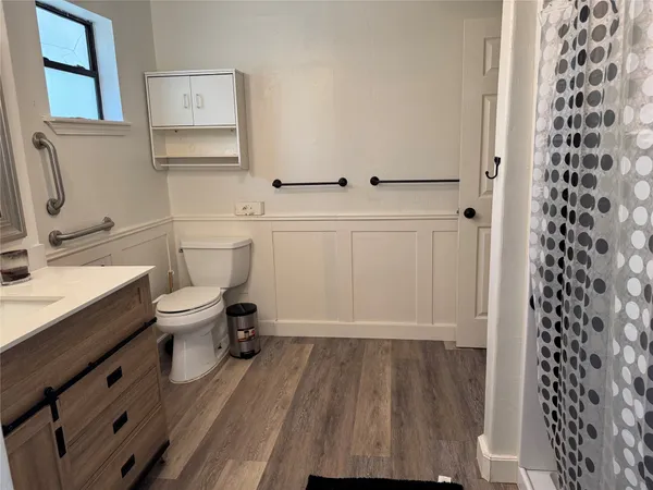 a bathroom with a sink toilet and shower