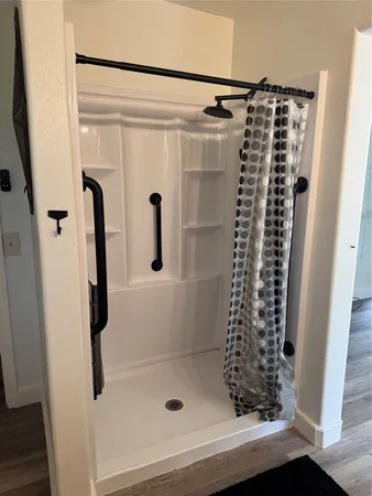 a bathroom with a shower and a glass door