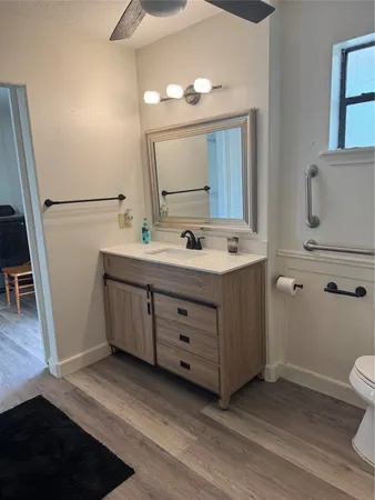 a bathroom with a double vanity sink mirror and toilet