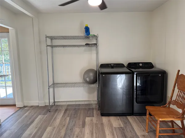a view of a room with wooden floor water heater and windows