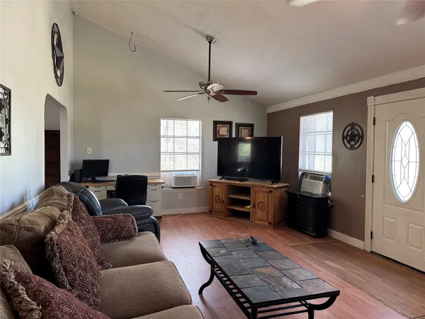 a living room with furniture and a flat screen tv