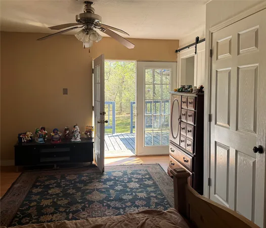 a living room with hard wood floor and a window
