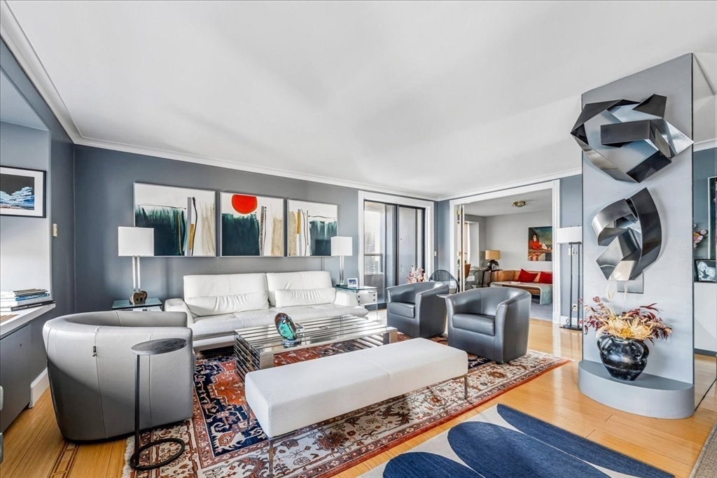 a living room with furniture and a mirror