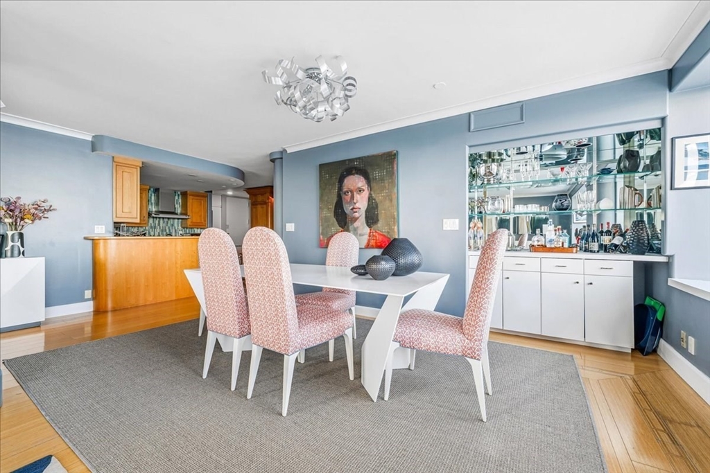 65 East India Row, Unit 26F Boston, MA 02110 - Photo 11 of 27 a dining room with furniture a rug and a chandelier