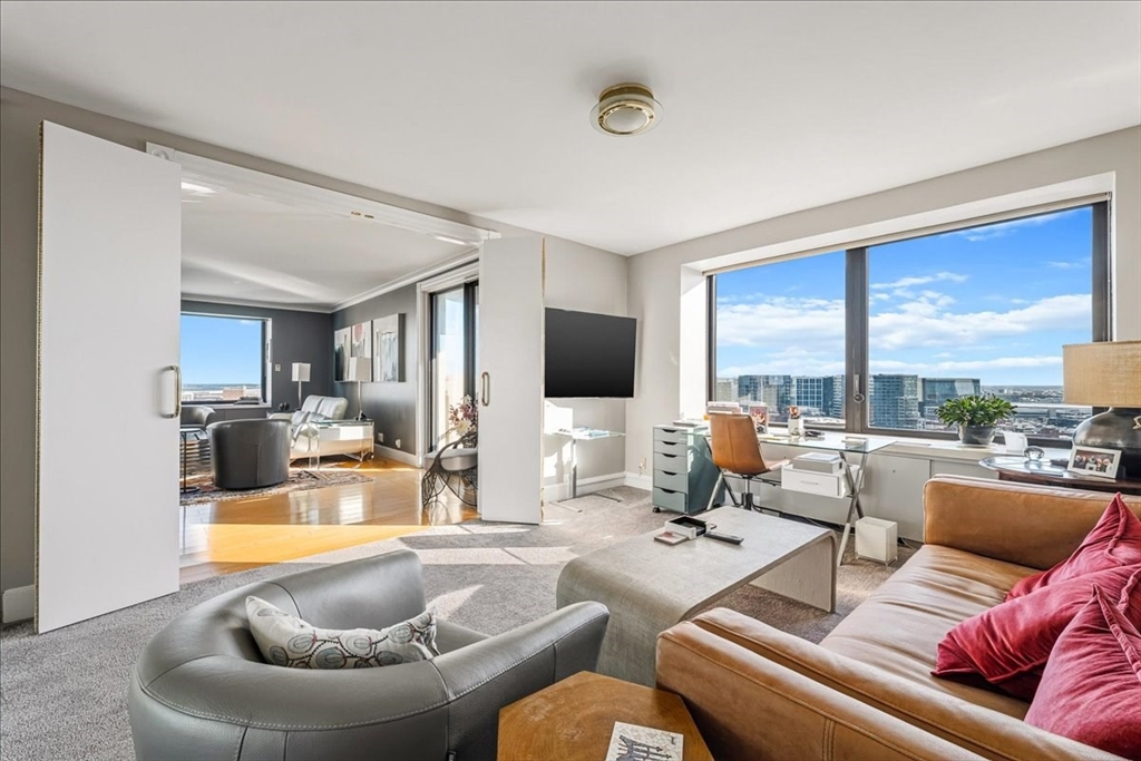 65 East India Row, Unit 26F Boston, MA 02110 - Photo 18 of 27 a living room with furniture and a large window