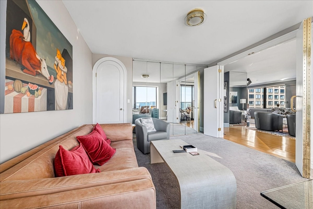 65 East India Row, Unit 26F Boston, MA 02110 - Photo 19 of 27 a living room with furniture and a flat screen tv