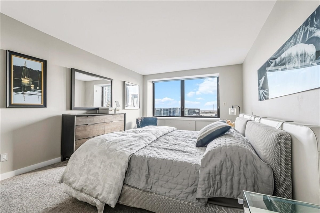 65 East India Row, Unit 26F Boston, MA 02110 - Photo 22 of 27 a bed room with a bed and a cabinets