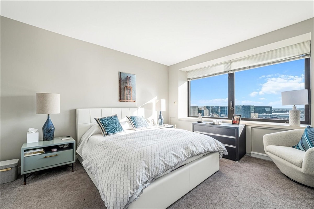 65 East India Row, Unit 26F Boston, MA 02110 - Photo 23 of 27 a bedroom with a bed and a couch
