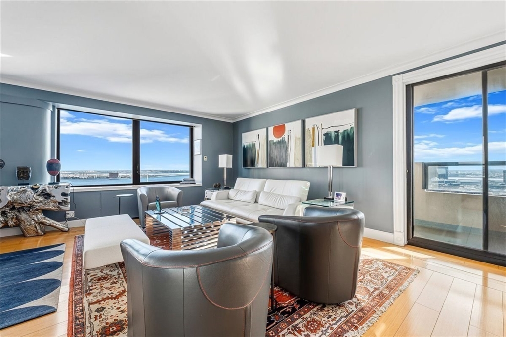 65 East India Row, Unit 26F Boston, MA 02110 - Photo 4 of 27 a living room with furniture and a large window