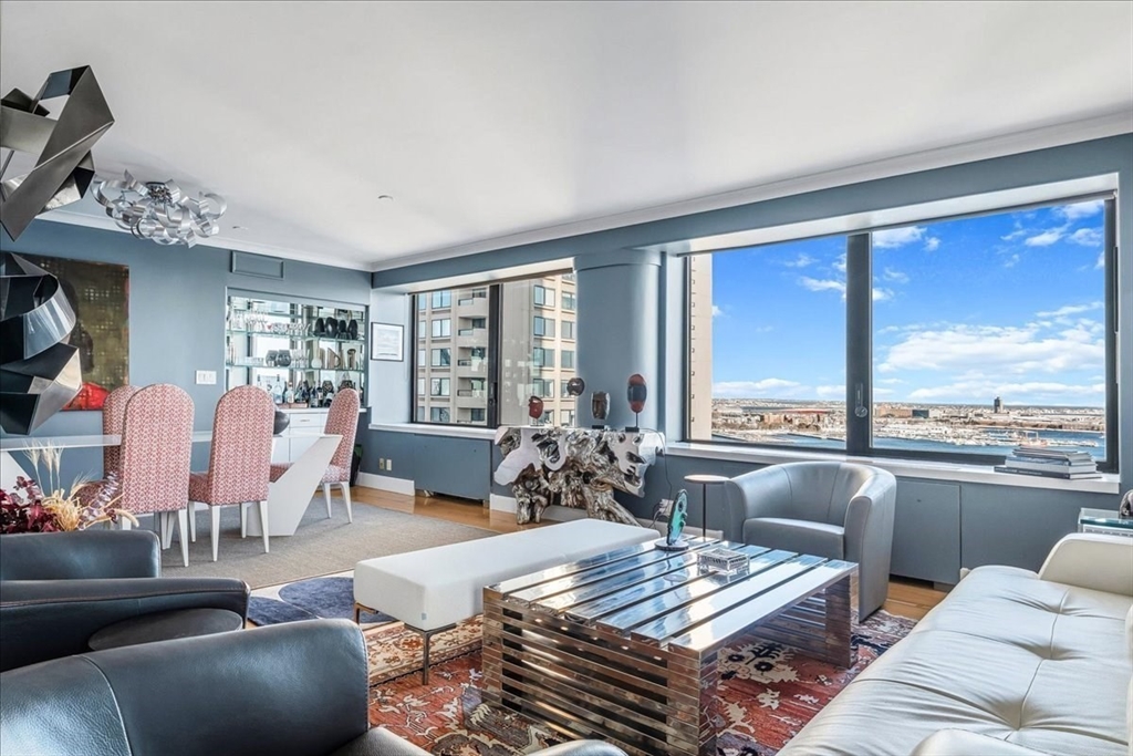 65 East India Row, Unit 26F Boston, MA 02110 - Photo 5 of 27 a living room with furniture and a large window
