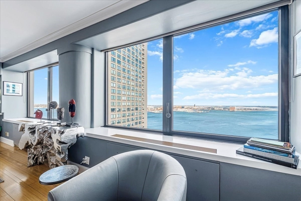 65 East India Row, Unit 26F Boston, MA 02110 - Photo 6 of 27 a living room with furniture and a large window