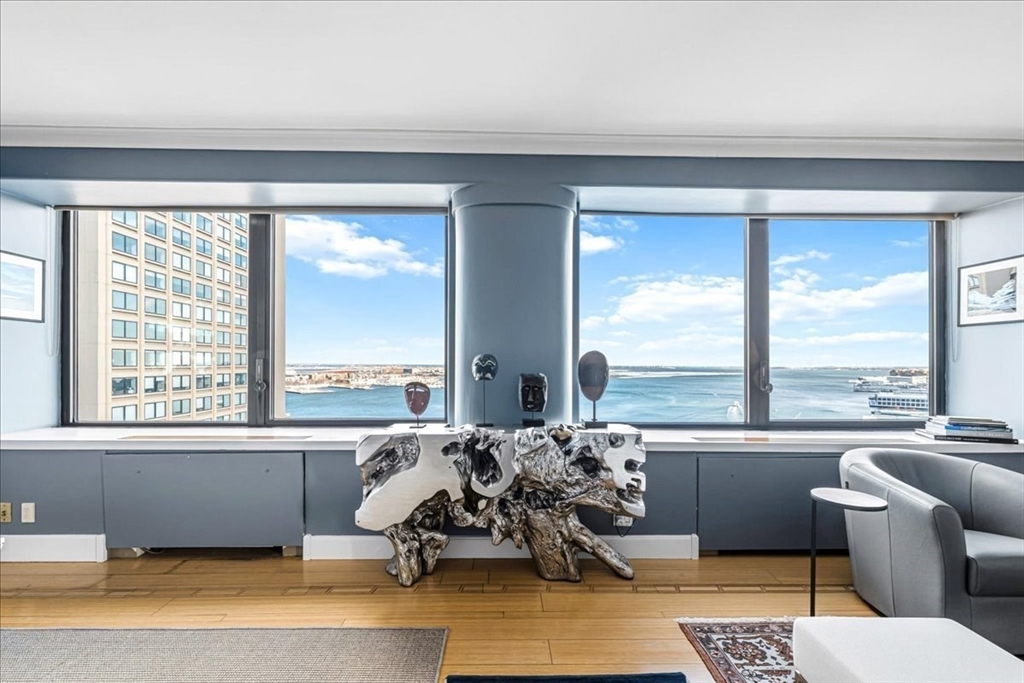 65 East India Row, Unit 26F Boston, MA 02110 - Photo 7 of 27 a living room with furniture and floor to ceiling windows