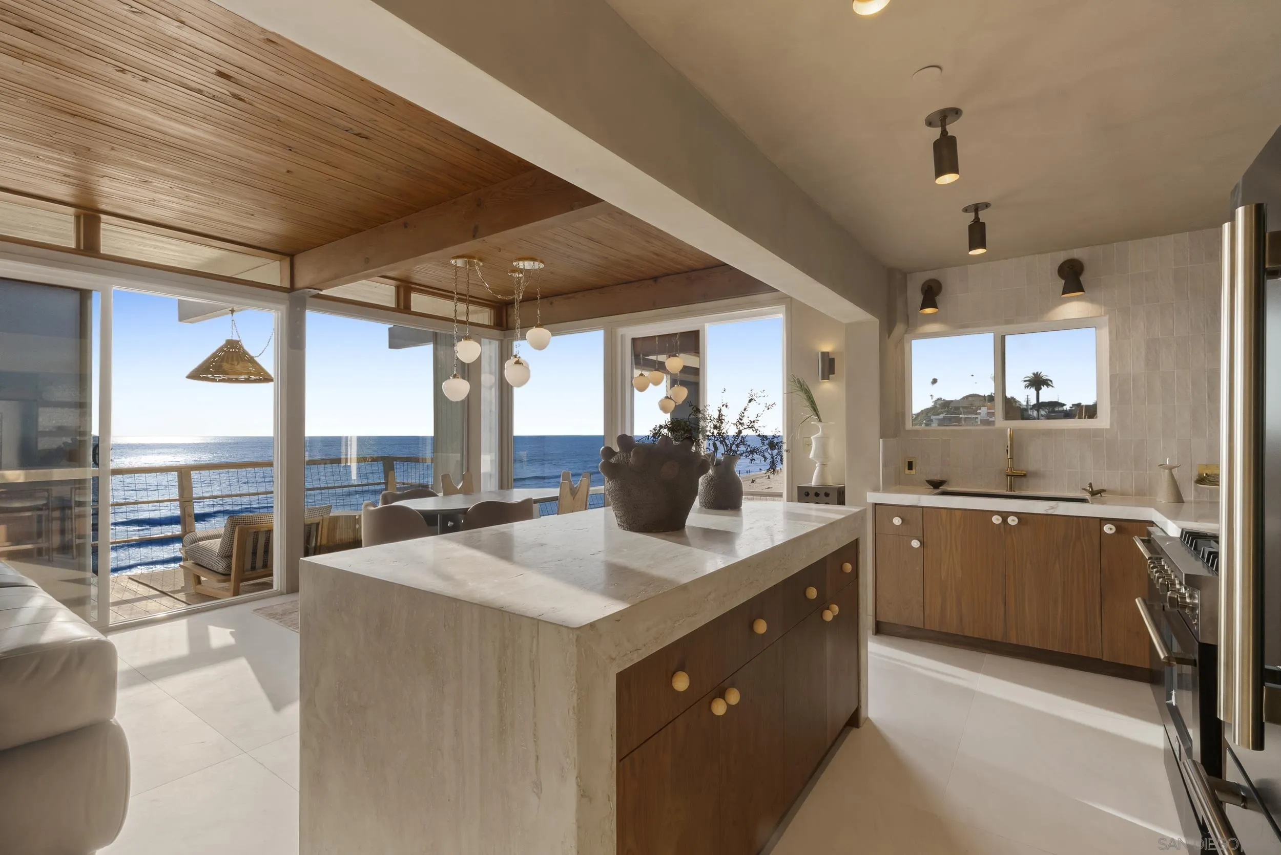 430 Moonlight Lane Encinitas, CA 92024 - Photo 6 of 28 a kitchen with sink cabinets and living room view