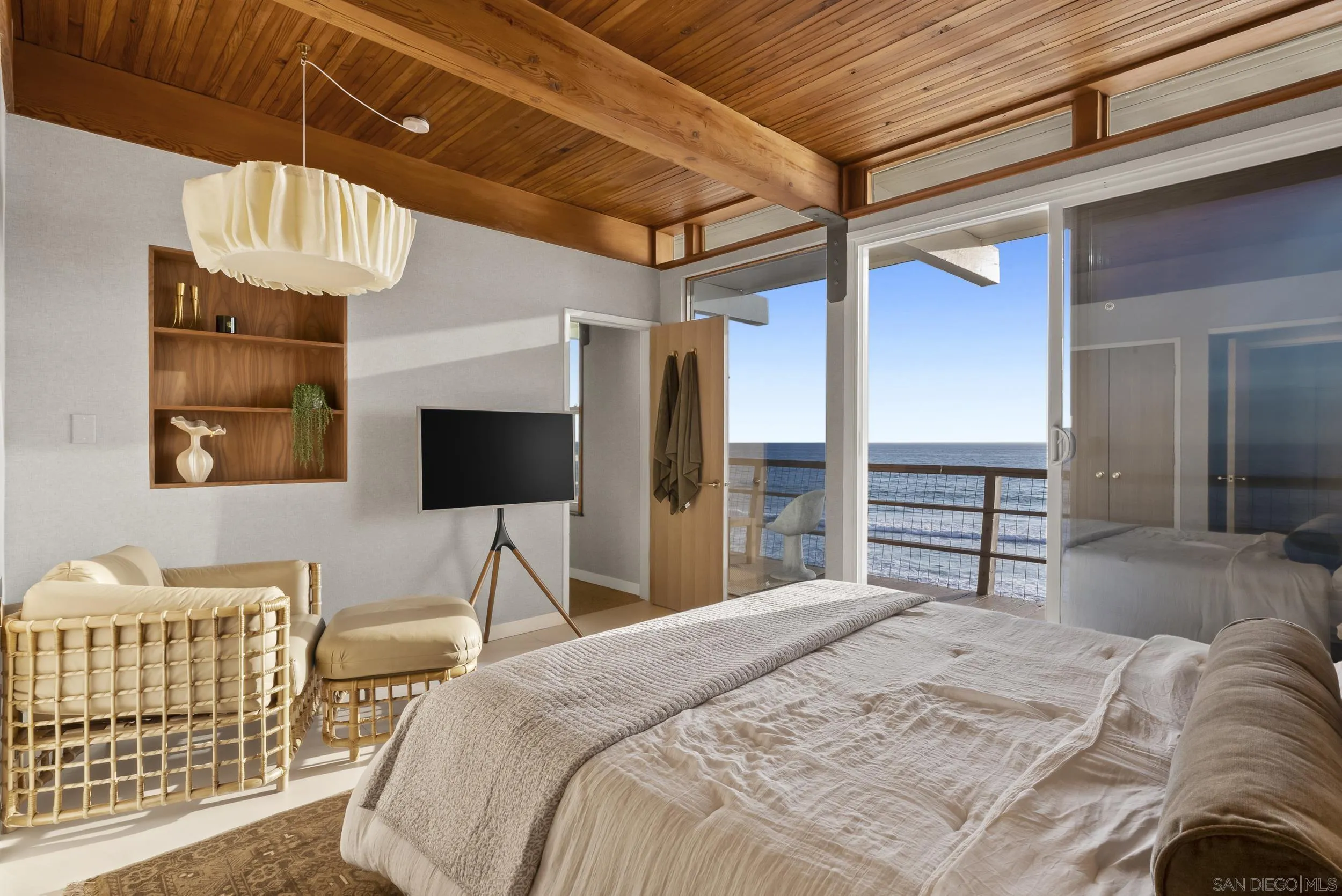 430 Moonlight Lane Encinitas, CA 92024 - Photo 9 of 28 a bedroom with a bed and a flat tv screen