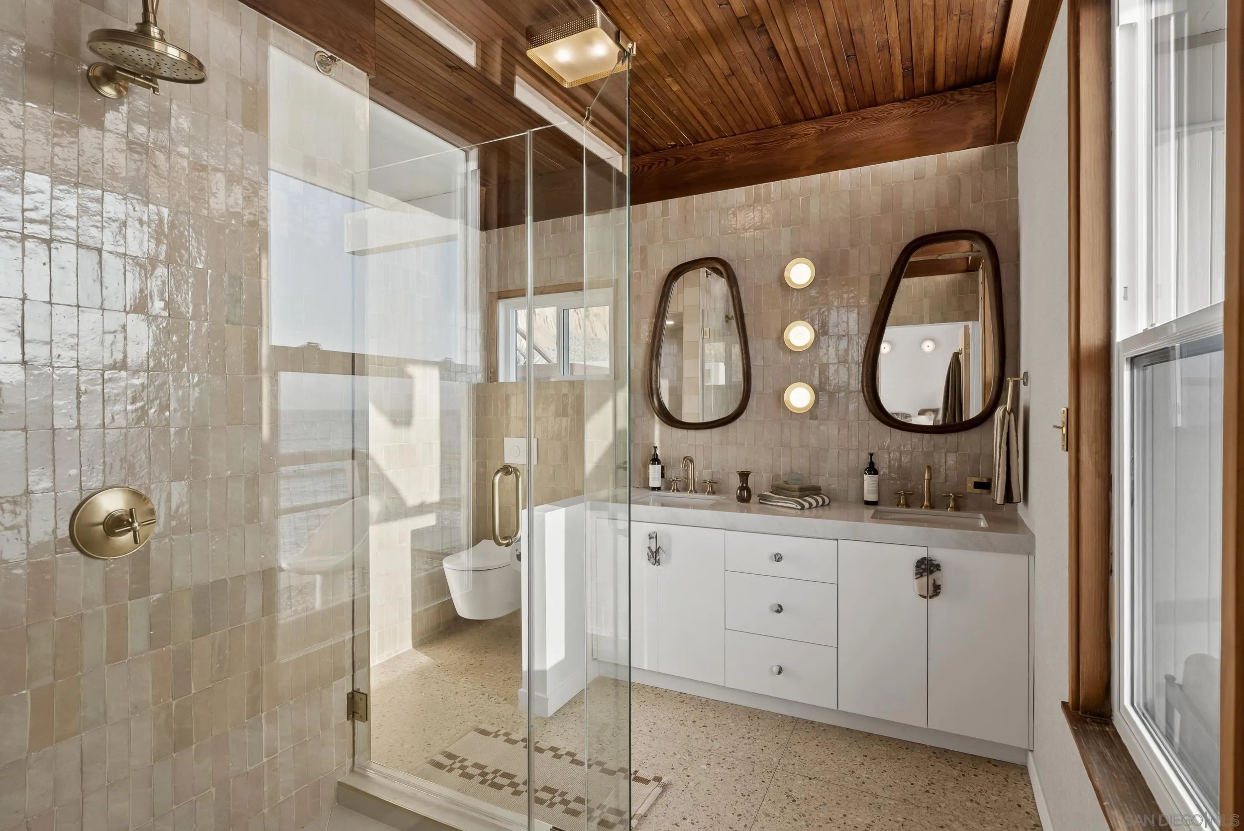 430 Moonlight Lane Encinitas, CA 92024 - Photo 10 of 28 a bathroom with a granite countertop sink a mirror and a shower