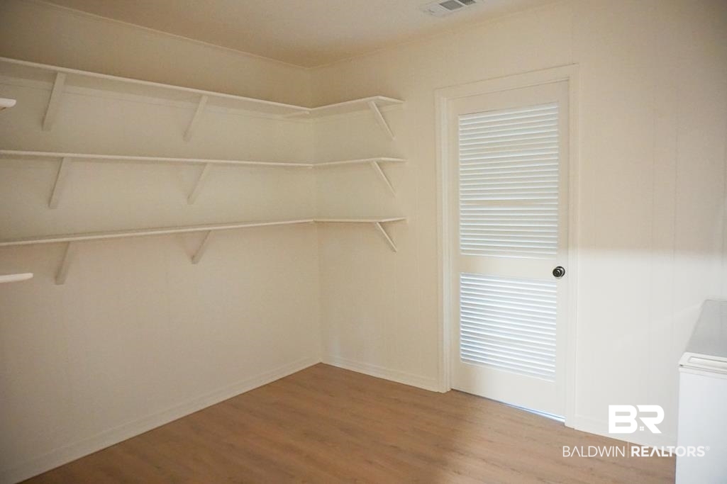 6205 Zeigler Boulevard Mobile, AL 36608 - Photo 15 of 17 Walk in closet featuring wood finished floors and washer / clothes dryer