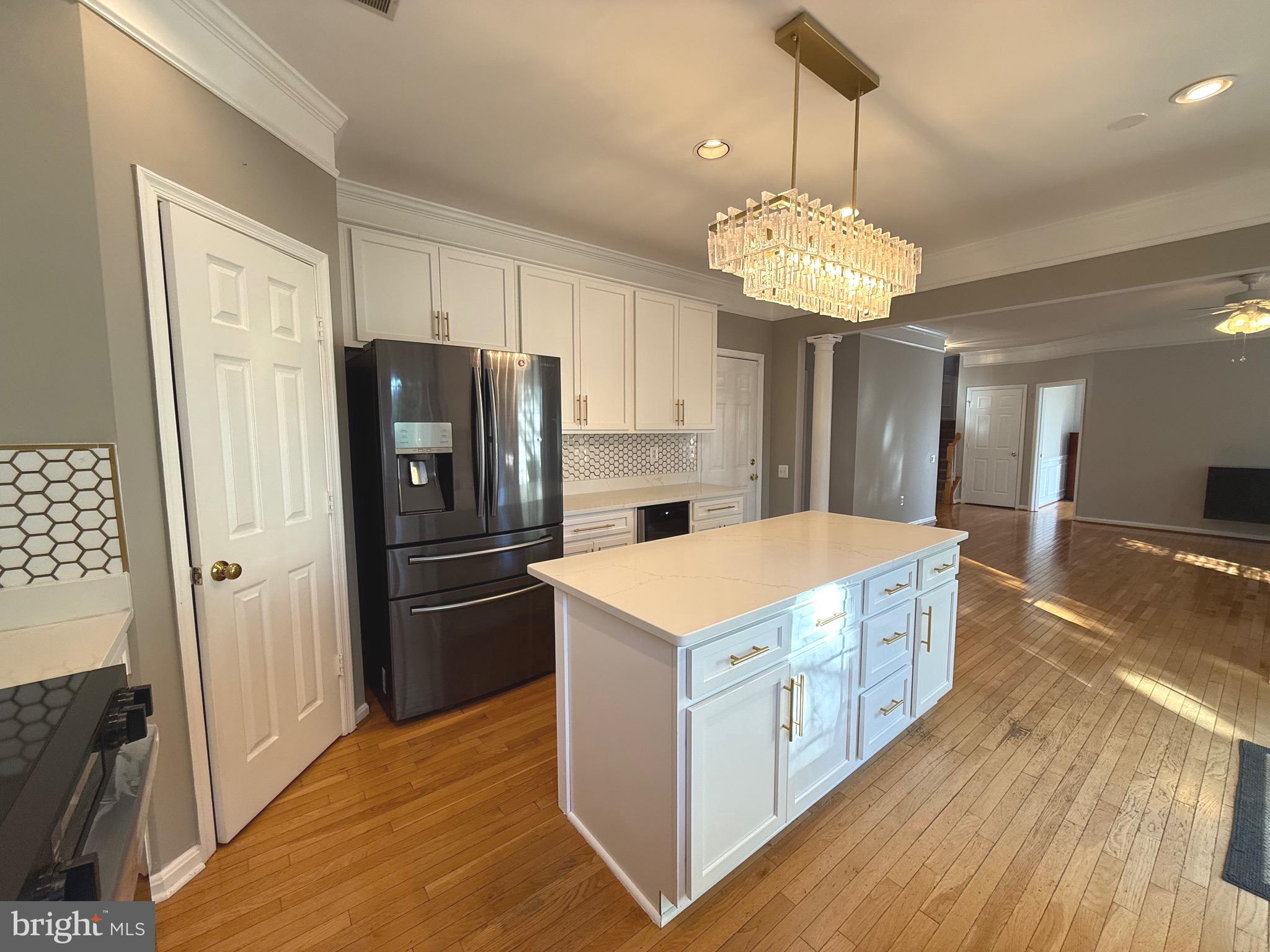1743 Wheyfield Drive Frederick, MD 21701 - Photo 11 of 47 a kitchen with kitchen island granite countertop a refrigerator a stove a sink dishwasher and a dining table with wooden floor