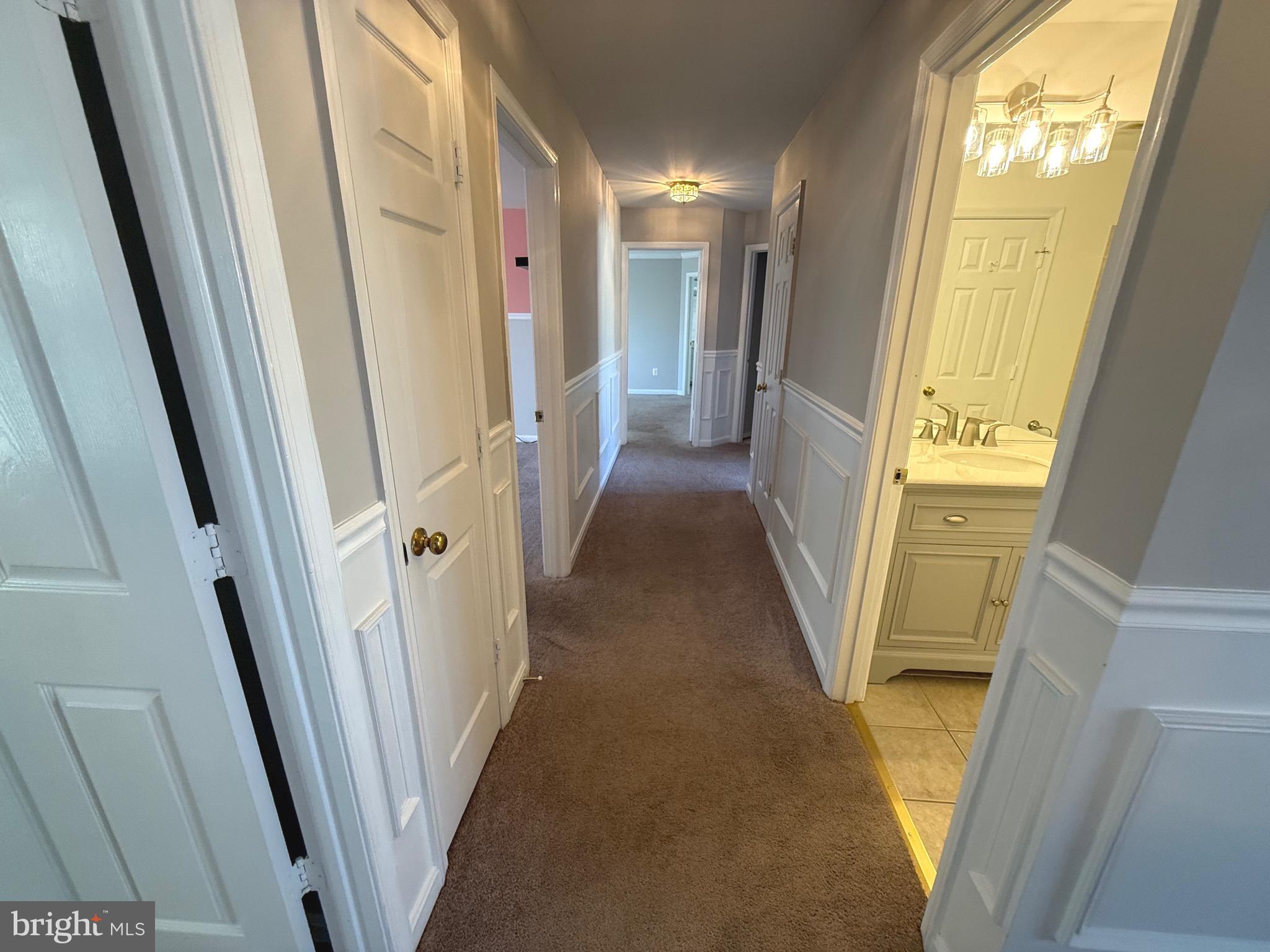 1743 Wheyfield Drive Frederick, MD 21701 - Photo 17 of 47 a view of a hallway with wooden floor and stairs