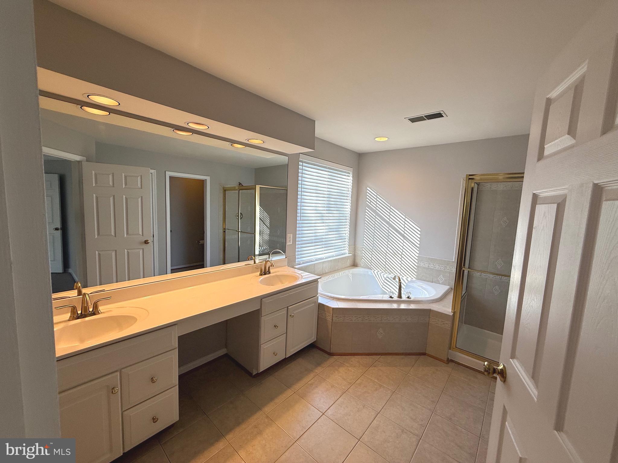 1743 Wheyfield Drive Frederick, MD 21701 - Photo 33 of 47 a bathroom with a tub sink and mirror