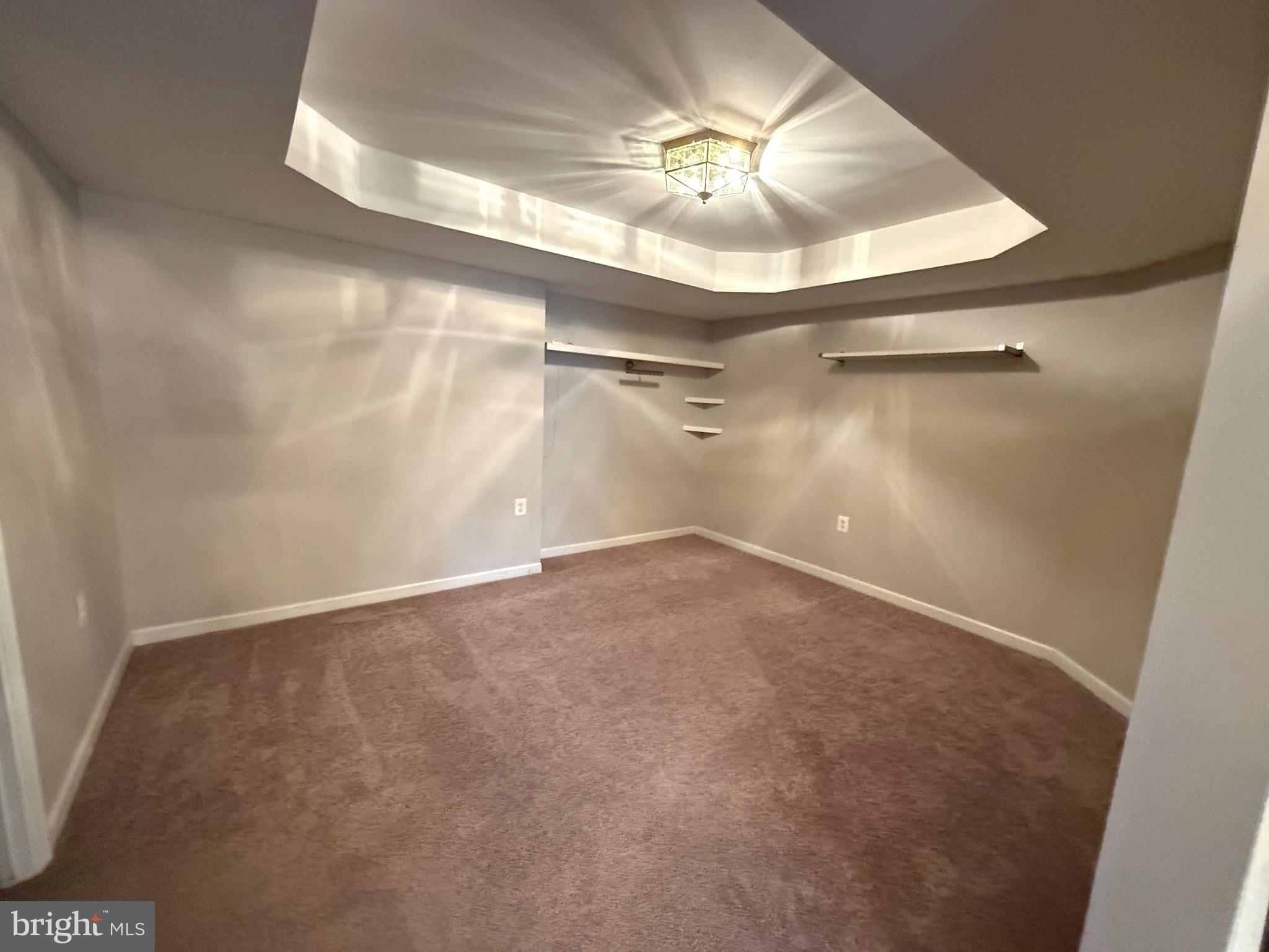 1743 Wheyfield Drive Frederick, MD 21701 - Photo 42 of 47 en empty room with a chandelier fan and wooden floor