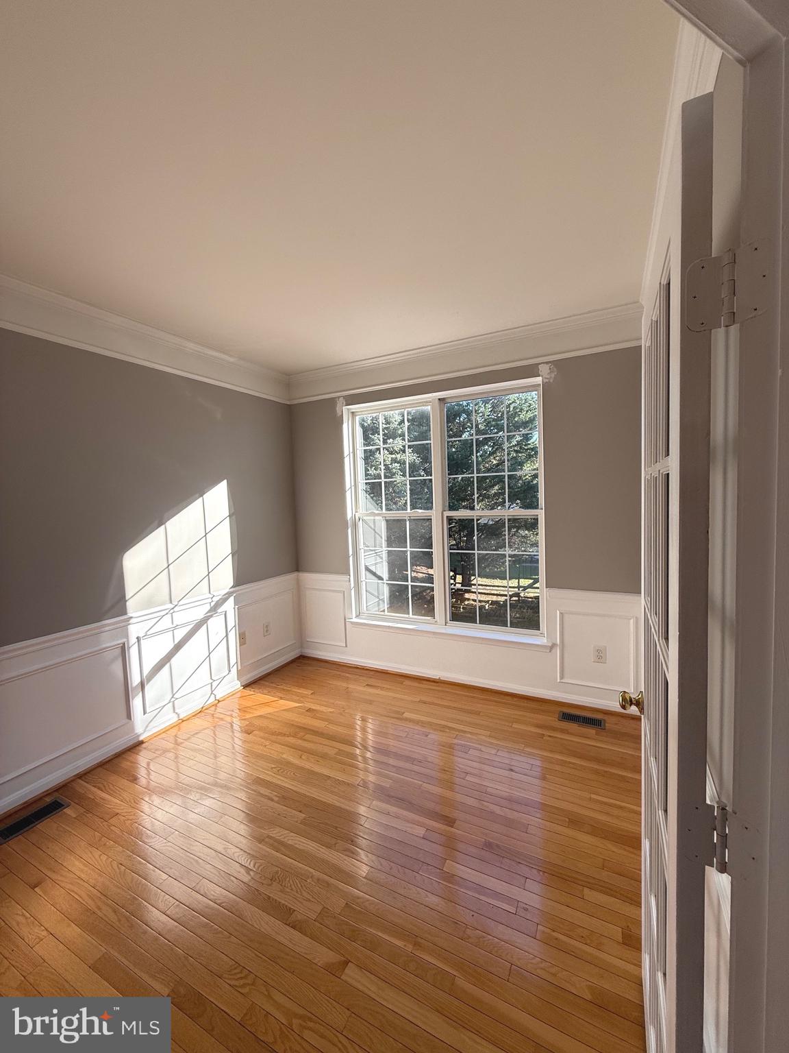 1743 Wheyfield Drive Frederick, MD 21701 - Photo 7 of 47 a view of an empty room with wooden floor and a window