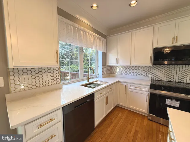 a kitchen with a sink stove and microwave