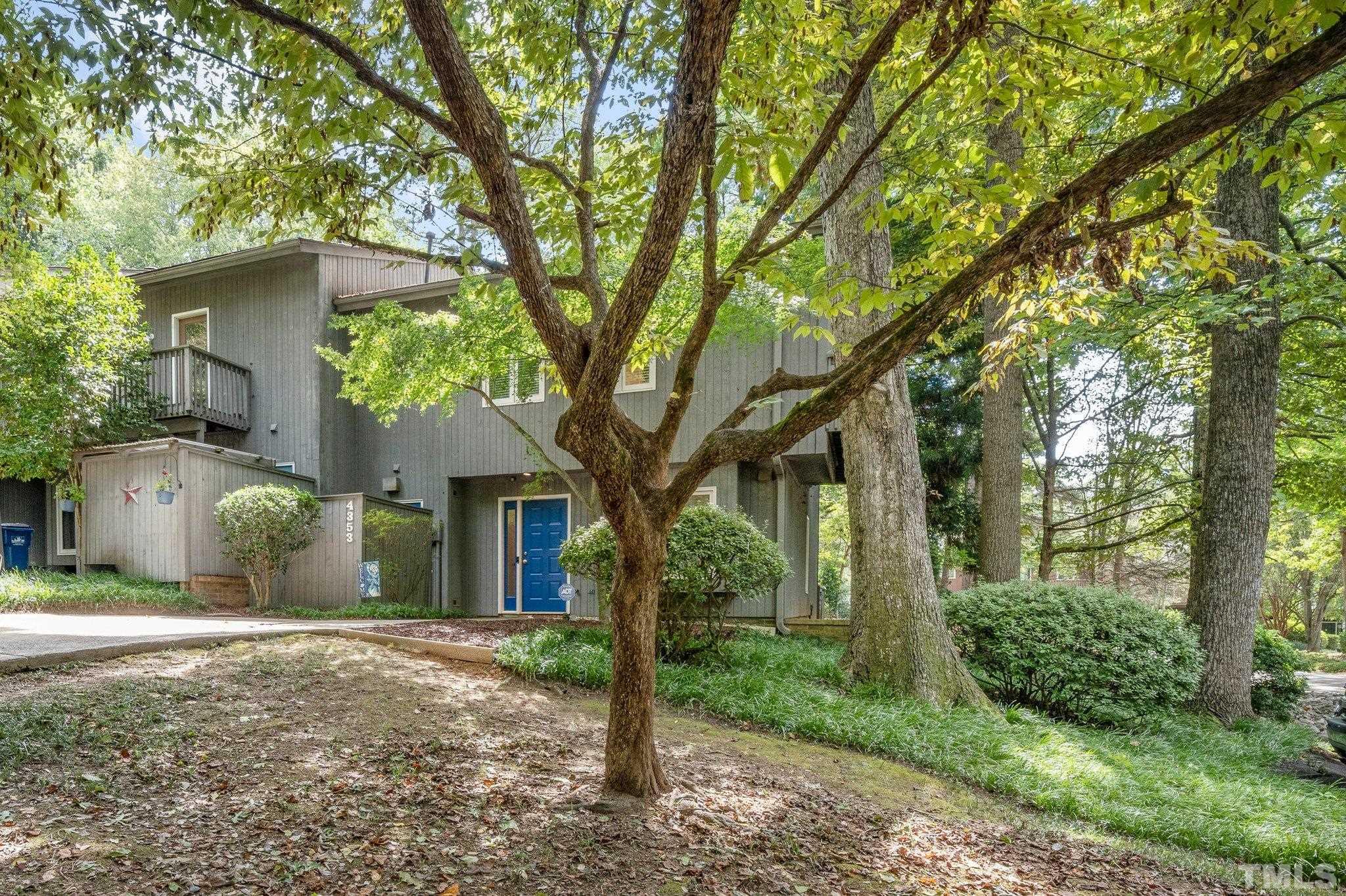 4353 Southwind Drive Raleigh, NC 27613 - Photo 2 of 23 a view of a house with a tree in the forest