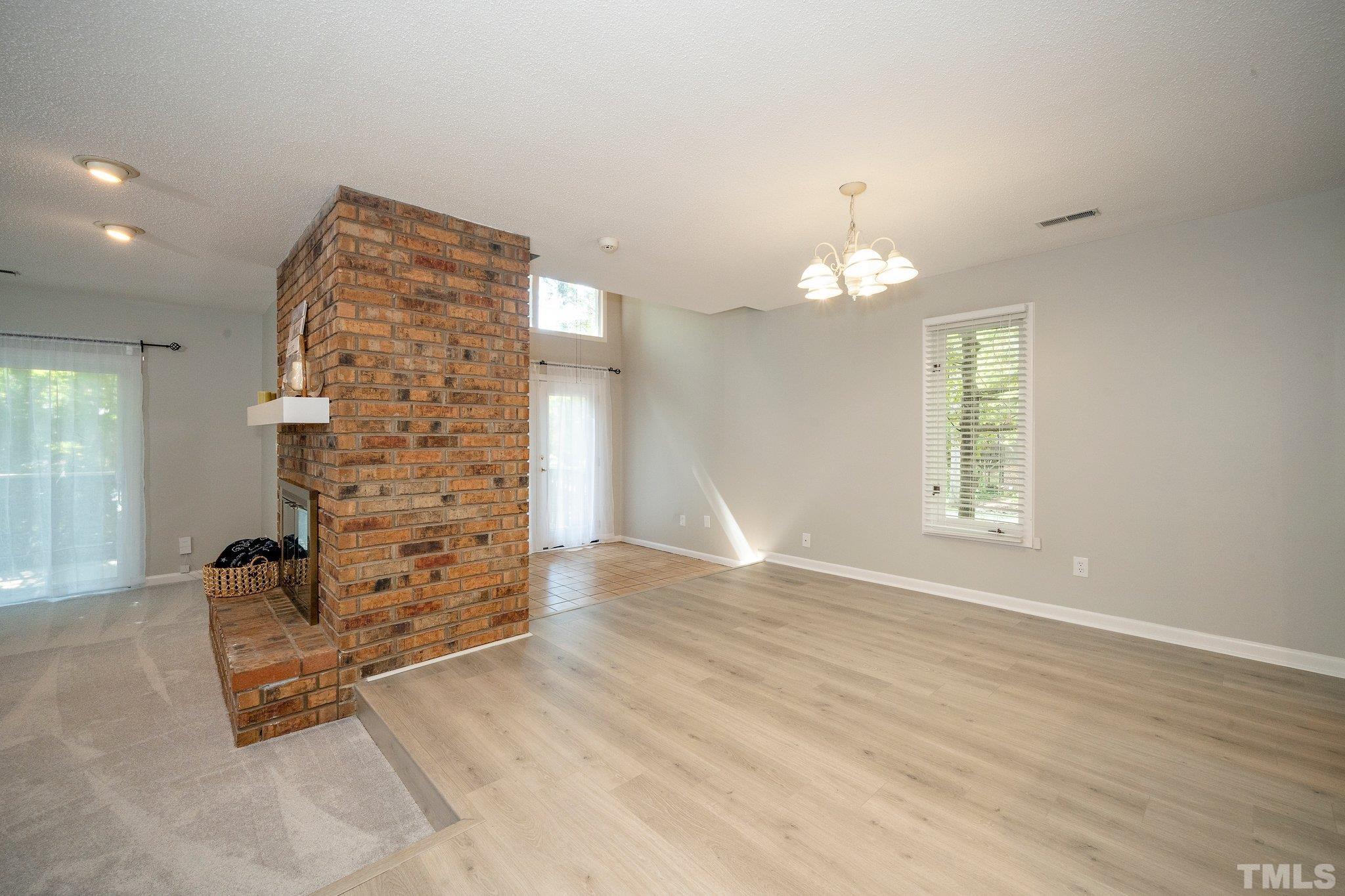 4353 Southwind Drive Raleigh, NC 27613 - Photo 5 of 23 wooden floor in an empty room with a window