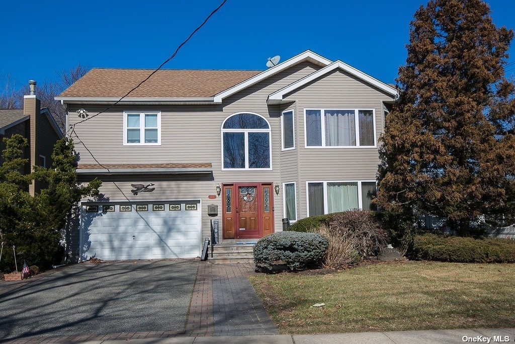 1745 Old Mill Road Merrick, NY 11566 - Photo 1 of 1 a front view of a house with a yard