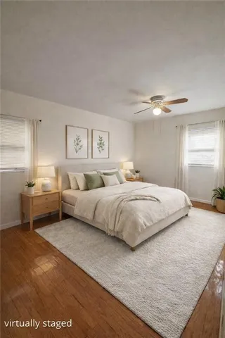 a bathroom with a double vanity sink toilet mirror and shower