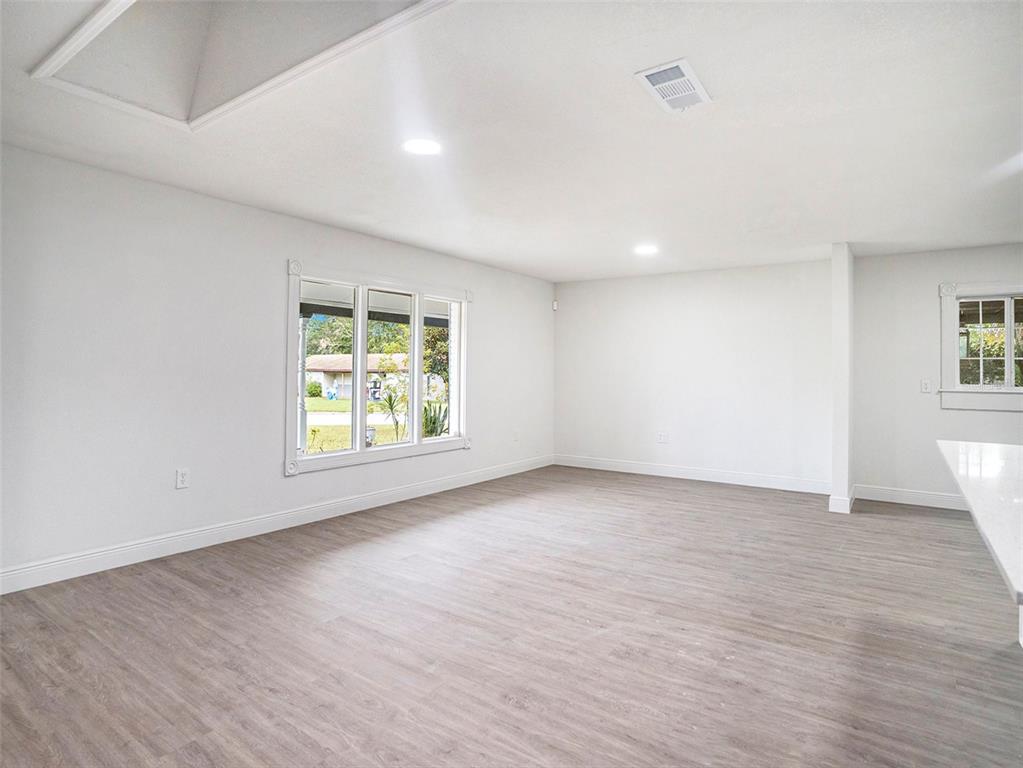 5136 Colbert Road Lakeland, FL 33812 - Photo 12 of 28 an empty room with wooden floor and windows