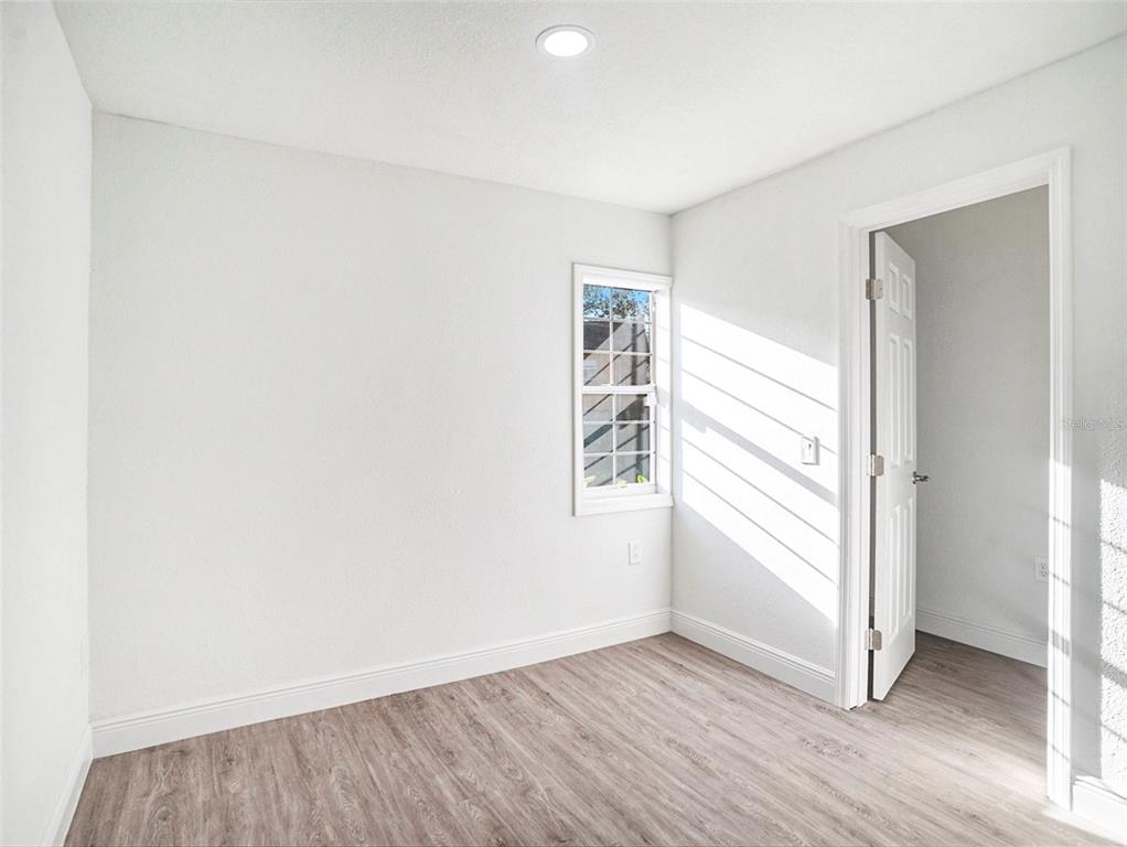 5136 Colbert Road Lakeland, FL 33812 - Photo 16 of 28 an empty room with wooden floor and windows